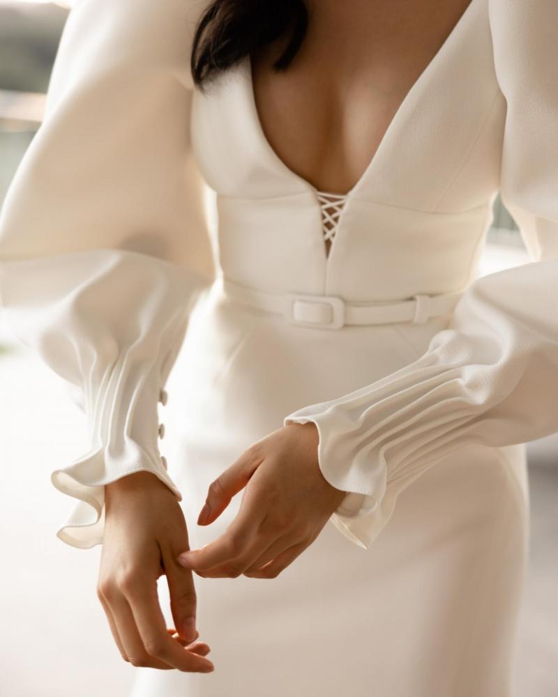 The Brooklyn bodice by Karen Willis Holmes, a plunging neckline simple wedding dress bodice with long sleeves and a simple fit and flare crepe wedding dress skirt.