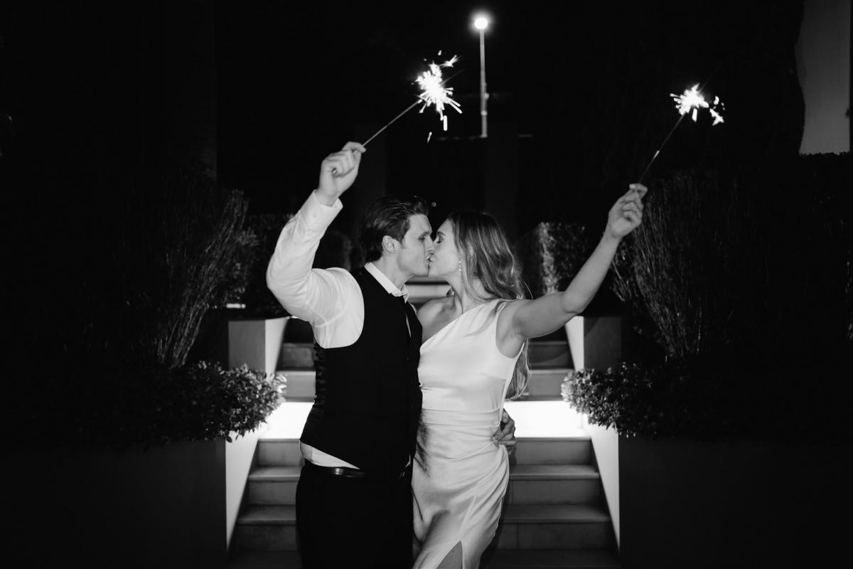 BW image of KWH real bride Demi and James sparkler send off. She wears the chich Charlie Danielle bridal suit.