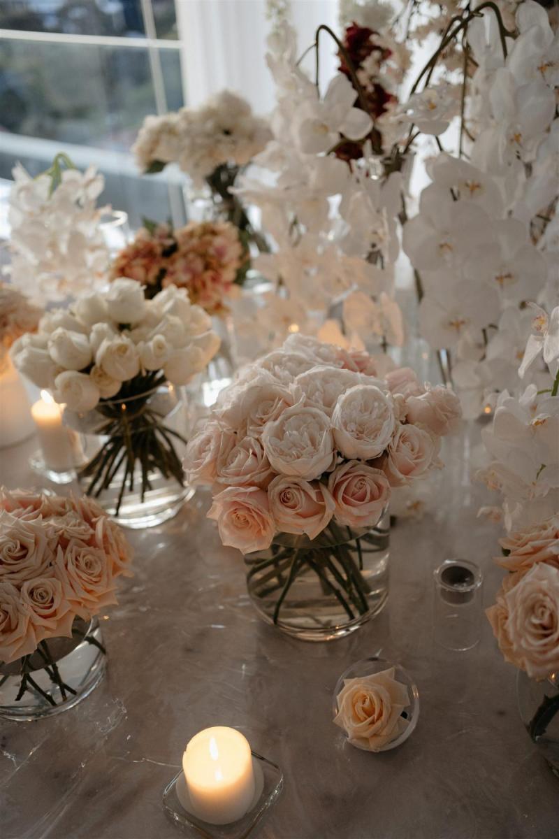 KWH real bride Demi's reception decor for their elopement with blush pinks and string lights over a long banquet table.
