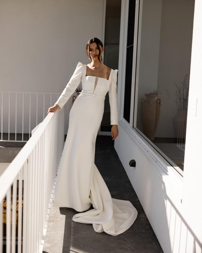 The Gwen & Fern gown by Karen Willis Holmes, a straight, plunging neckline crepe wedding dress with straps or long sleeves. and fit and flare skirt..