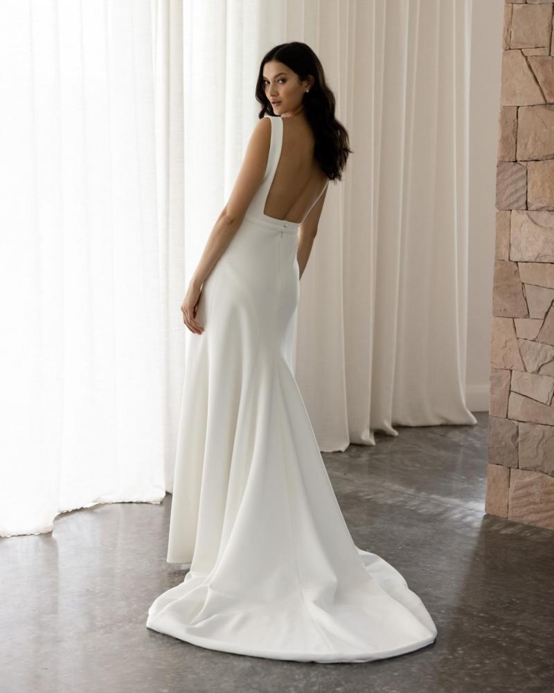 The Gwen & Fern gown by Karen Willis Holmes, a straight, plunging neckline crepe wedding dress with straps or long sleeves. and fit and flare skirt.