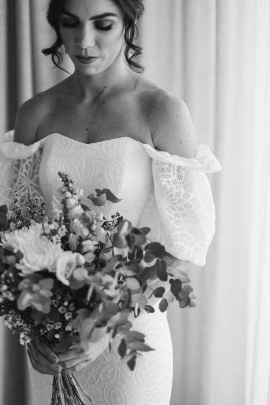 B&W bridal portrait of KWH real bride Tess in her Vivienne wedding dress; a fitted lace wedding dress with structured bodice and puff sleeves.