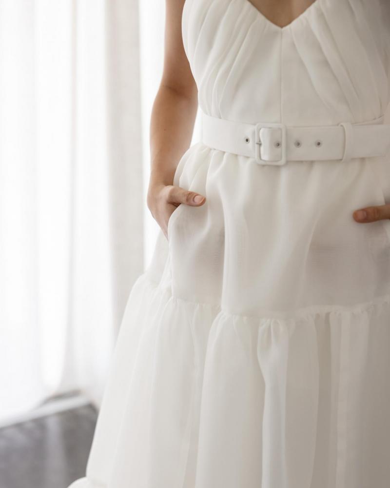 Zoomed in image of the belt on the Zaidee Amira by Karen Willis Holmes; a modern boho wedding dress with spaghetti straps and tiered a-line skirt.