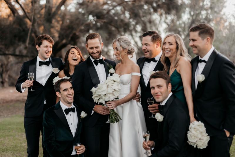 KWH real bride Genevieve walks through the woods with ballgown skirt and high leg split and bustier top.