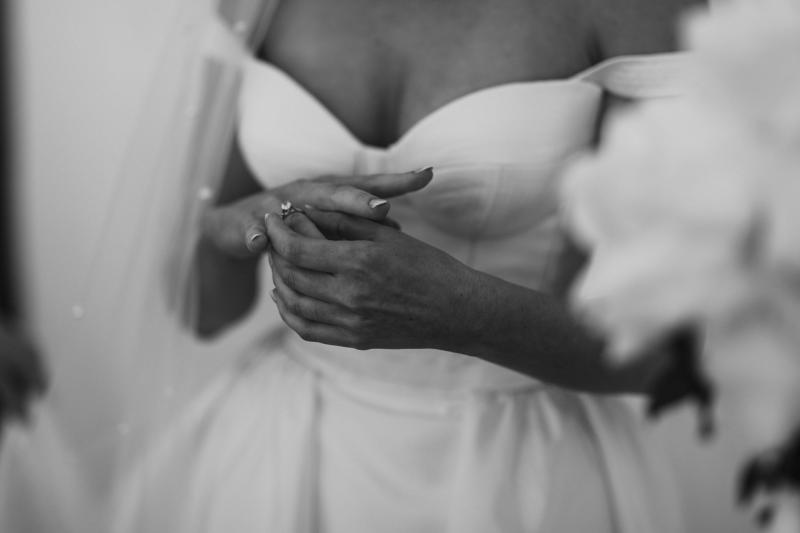 B&W image of KWH real bride Genevieve wearing her satin Blake Camille wedding dress; a timeless a-line skirt with bustier top.