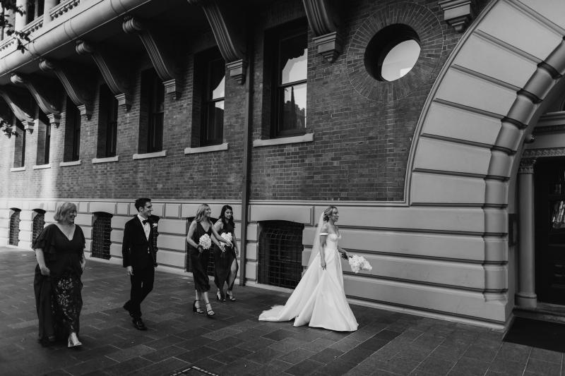 KWH real bride Genevieve by the window wearing her A-line wedding dress, Blake Camille, with bustier bodice and pearl veil'.