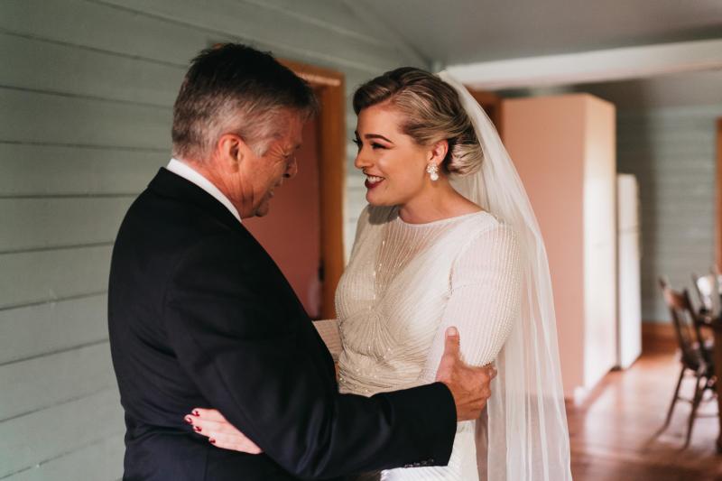 KWH real bride Nicola sees her dad for the first time in her Cassie wedding dress; a fitte, hand-beaded, art deco inspired dress.