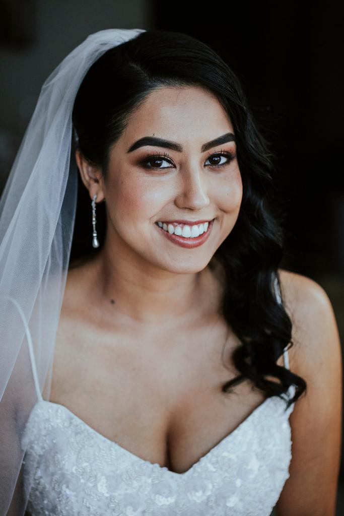 Up close portrait shot of KWH real bride Jaz in her veil and Darcy gown, a v-neck fit and flare beaded wedding dress
