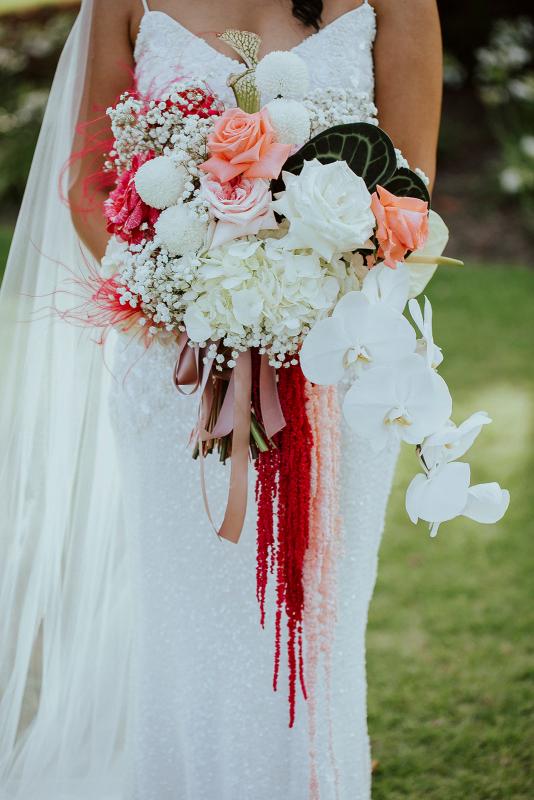 Detail photo of KWH Real bride Jaz's bright pink and white bridal bouquet. She wears the sparkly Darcy gown, a modern v-neck beaded wedding dress.
