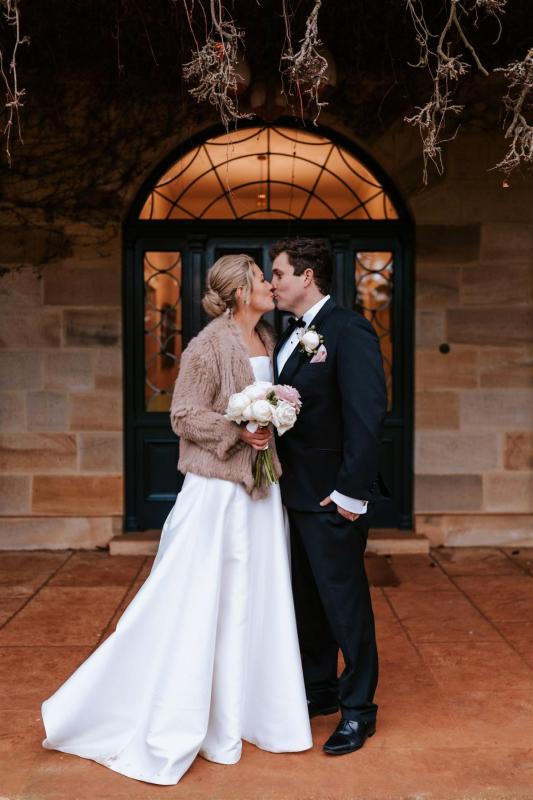 KWH real bride Annabelle kisses Will in her modern Jacqueline Melanie gown, a classic strapless aline wedding dress.