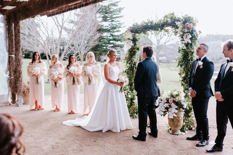 KWH real bride Annabelle standing with Will at the alter in her stunning Jacqueline Melanie gown, a modern ballgown with strapless bodice.