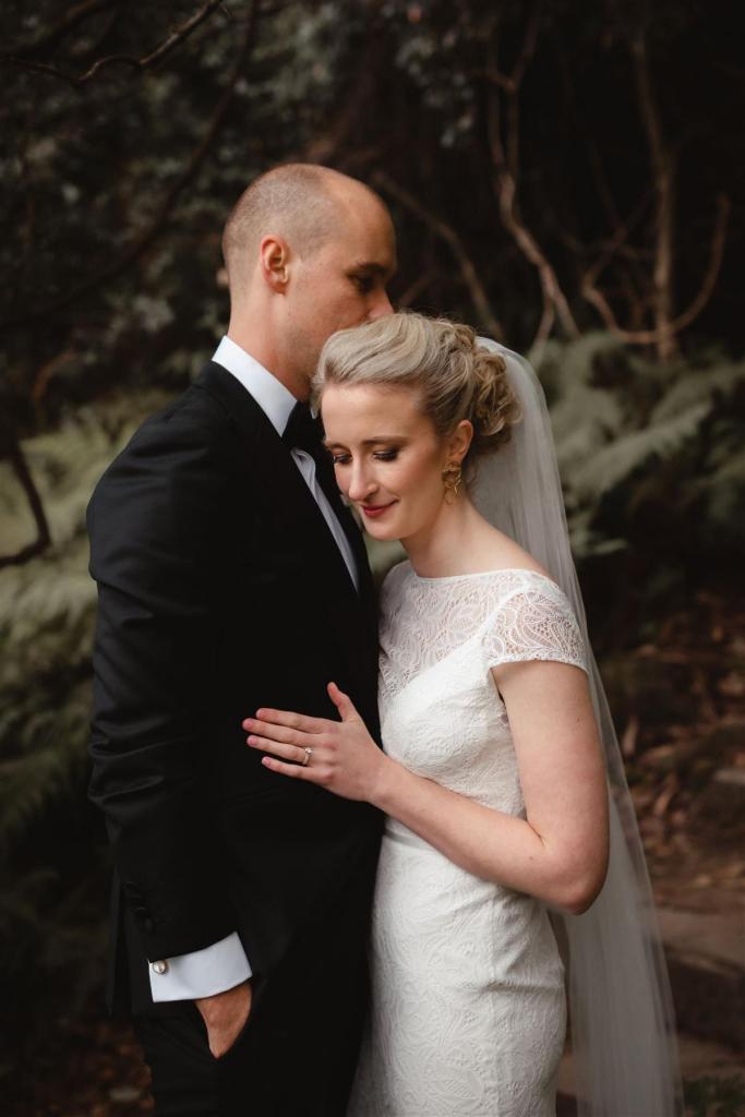 KWH real bride Gemma hugging Rob in her Jemma gown, a modern high neck lace wedding dress.