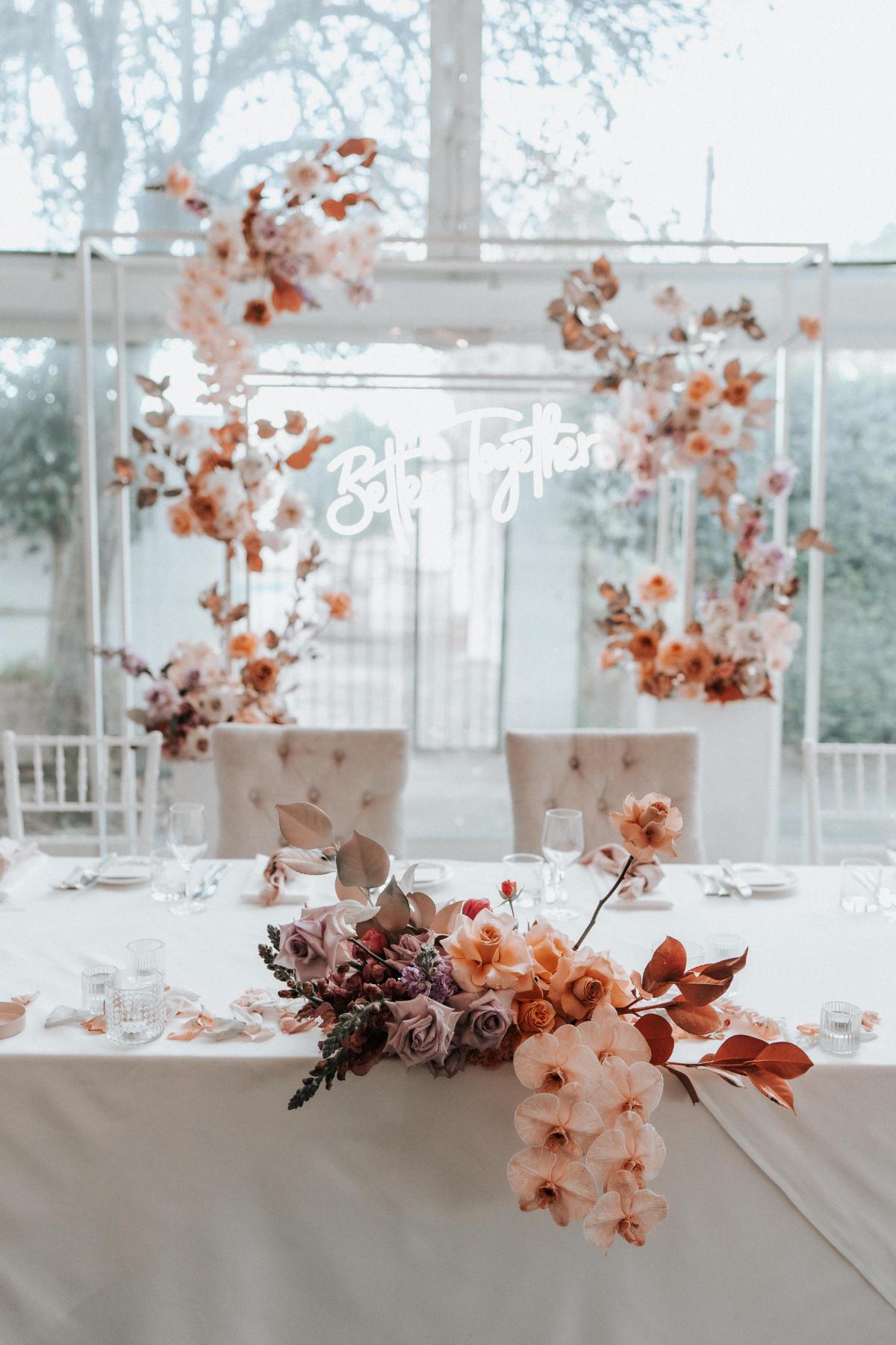 KWH real bride Katherine's wedding florals on their wedding table with neon 