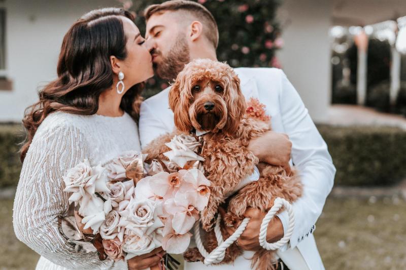 KWH real bride Kahterine and Conor looking at each other. She wears the Margareta gown, a high neck backless wedding dress