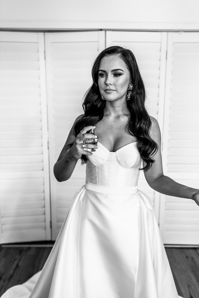 KWH real bride Hannah sprays some perfume in her Blake Camille gown, a modern strapless aline wedding dress.
