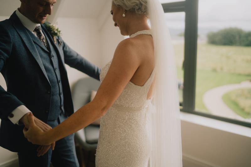 KWH real bride Laura has her first look with David in her Cindy gown, a halter neck sequin wedding dress.