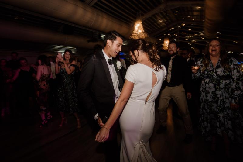KWH real bride Jacqui and Chris dance the night away. She wears the Clarissa gown, a high back fit and flare cap sleeve wedding dress.