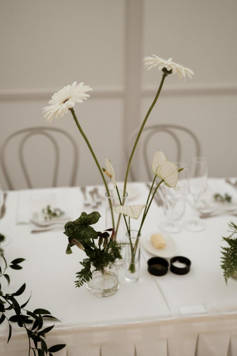 Minimalist details of KWH real bride Jacqui's reception table with white daisies.