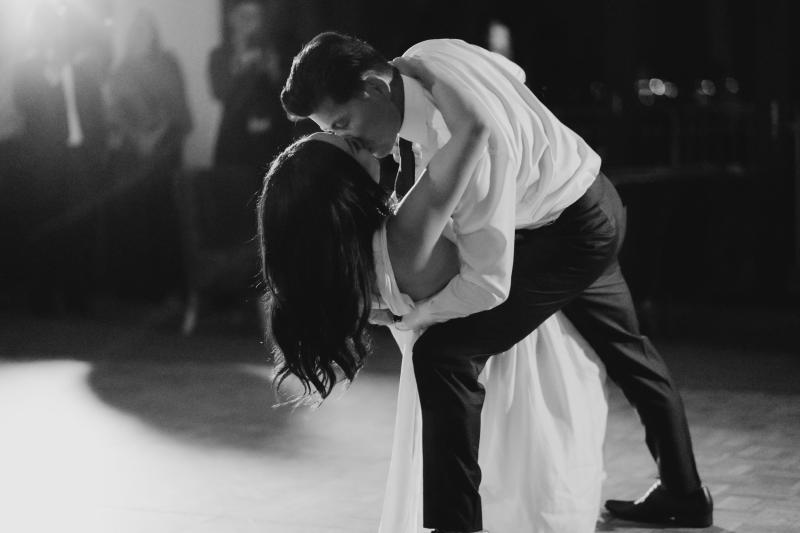 B&W image of KWH real bride Vicki and Tom having their first dance. She wears the Arabella gown, lunging neckline simple wedding dress.