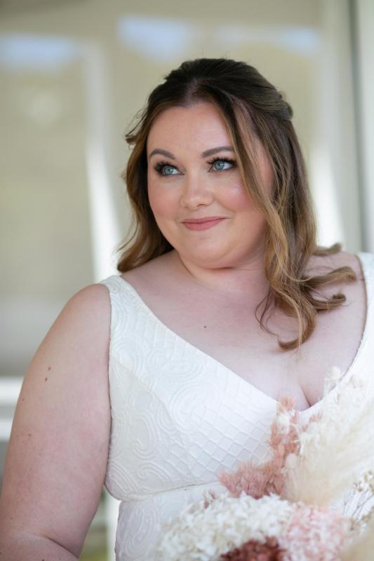 KWH real bride Meg has her bridal portrait done in her bobby gown, a curve fit and flare lace wedding dress.