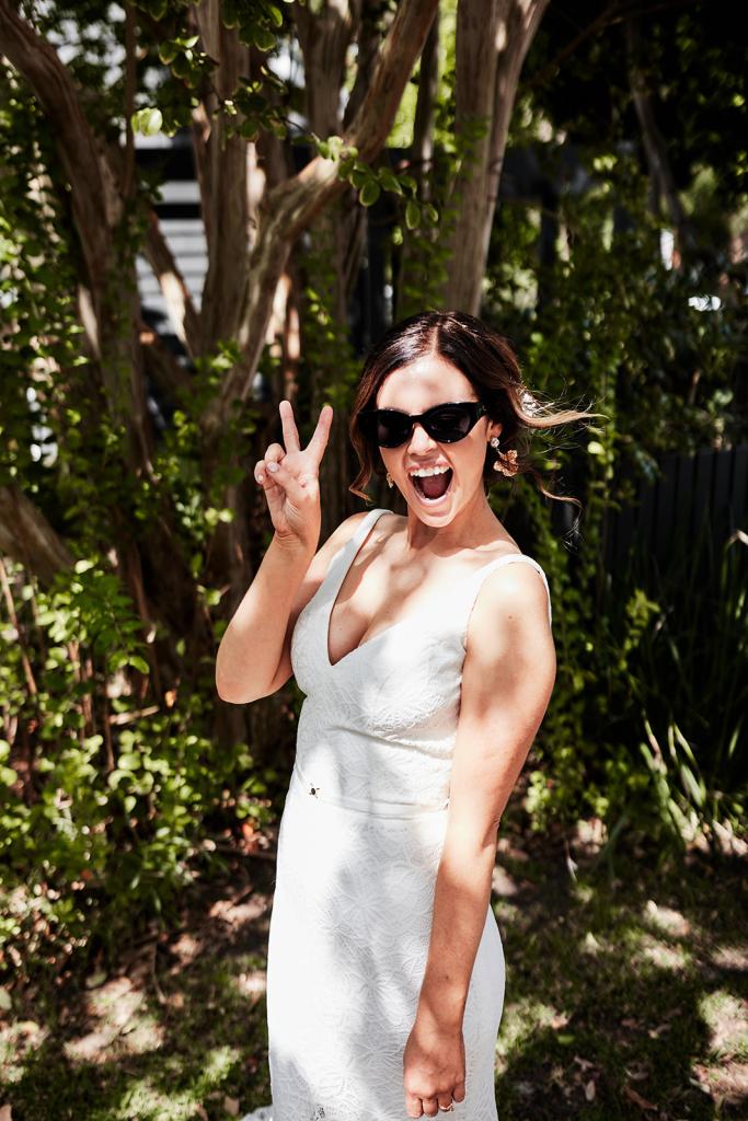 KWH real bride Emma wears her cool bridal sunglasses in her Rylie gown, a modern lace fit and flare wedding dress.