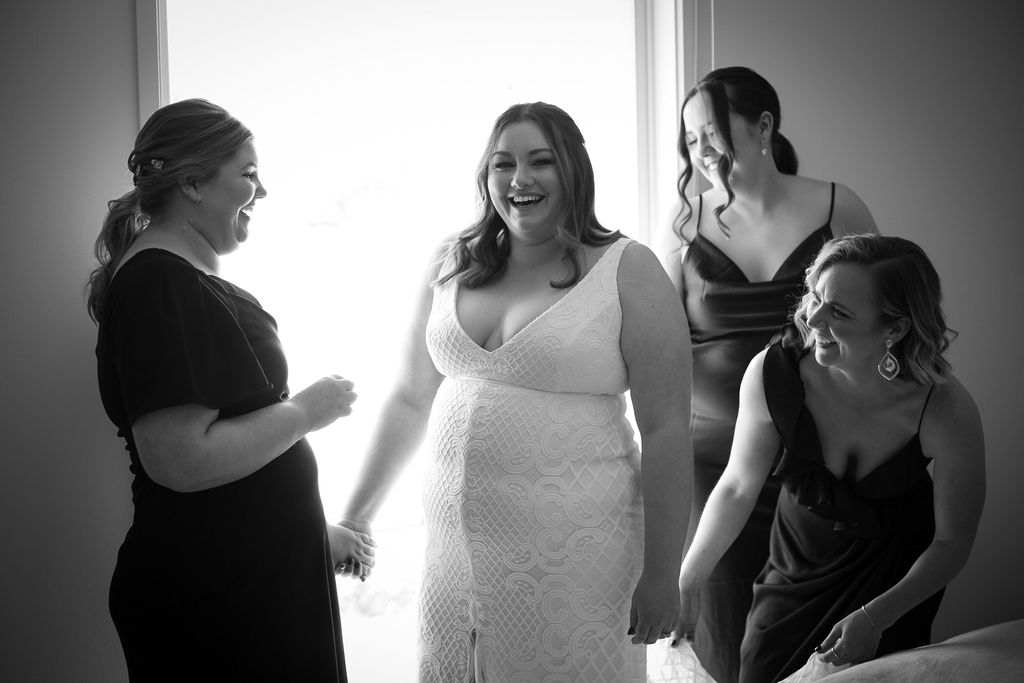 KWH real bride Meg gets ready with her bridesmaids in her Bobby gown, a modern curve fit and flare wedding dress