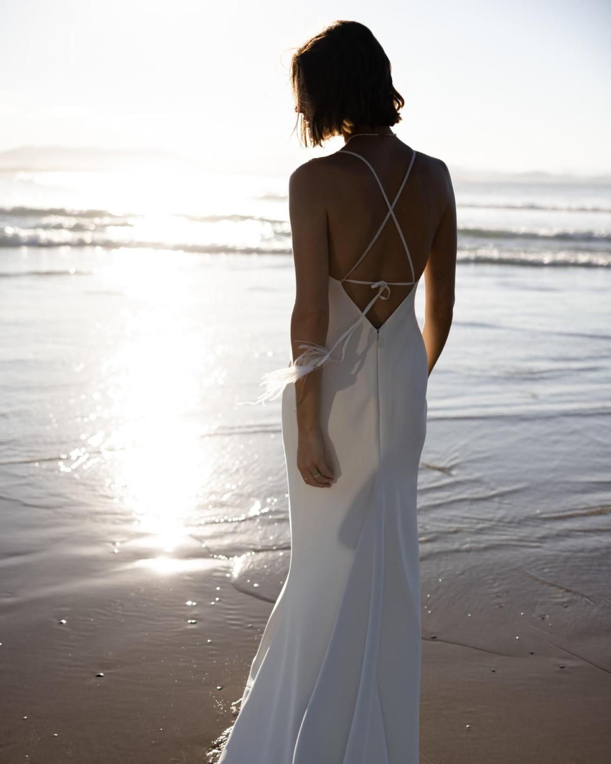 The Isadora gown by Karen Willis Holmes, a V-Neck, simple crepe wedding dress with open back.