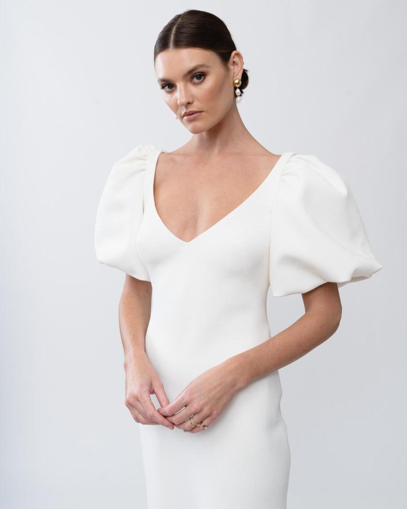 Upclose of the Shelby gown by Karen Willis Holmes, a minimalist crepe wedding dres with wide V-neck and bubble sleeves.