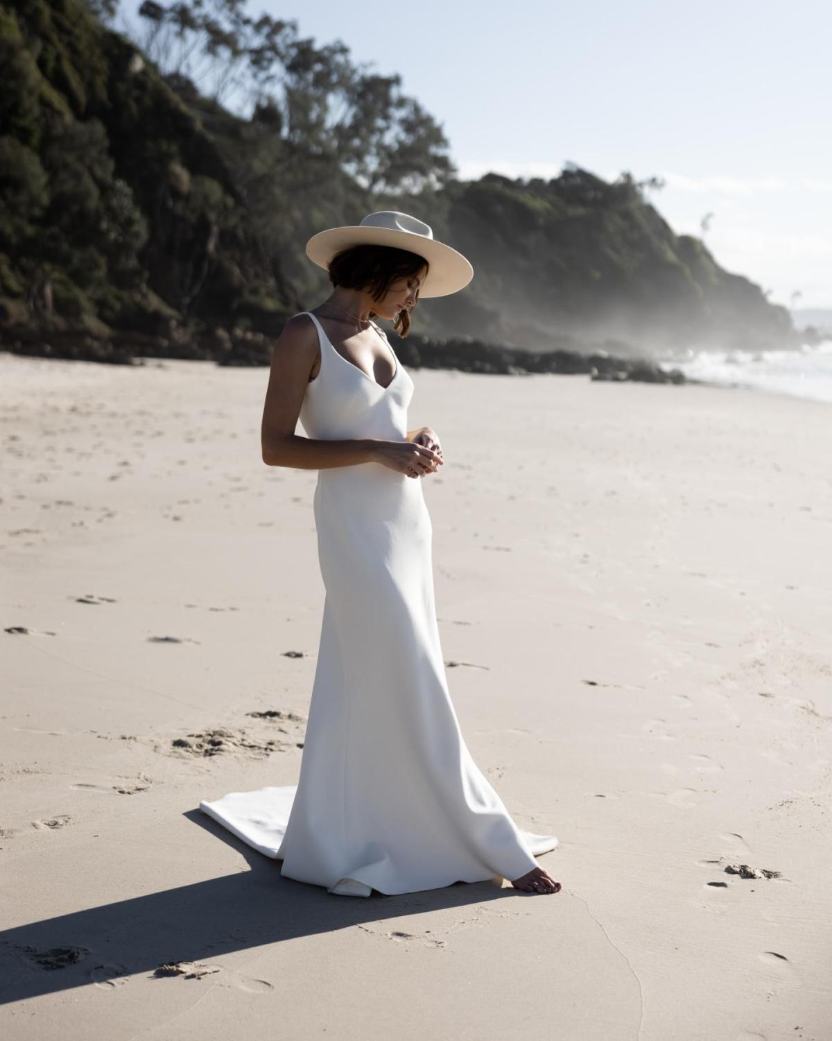 The Shelby gown by Karen Willis Holmes, a V-Neck, simple slip wedding dress with a fit and flare shape and open back.