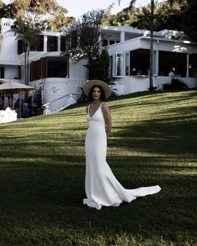 The Shelby gown by Karen Willis Holmes, a sophisticated crepe fit and flare wedding dress with deep V-neck.