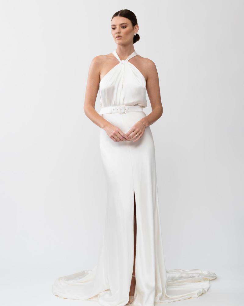 The Tammy gown by Karen Willis Holmes, a high neckline, simple satin bias cut wedding dress with a split skirt.
