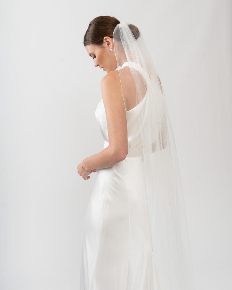 The Tammy gown and Lucienne veil 250cm by Karen Willis Holmes, a high neckline, simple satin bias cut wedding dress with a split skirt.