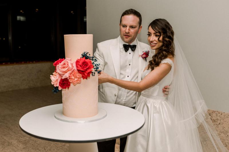 B&W image of KWH real bride Josey and Brad kissing. she wears the modern Taryn Camille gown, a timeless aline wedding dress with custom cap sleeves.