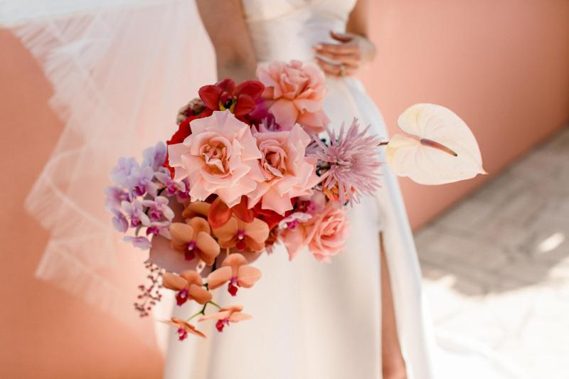 KWH real bride Josey and Brad kiss in front of the skyline as she wears the grand Taryn Camille gown, a modern aline wedding dress with U-shaped neckline.