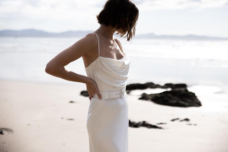 The Tiffany gown by Karen Willis Holmes, a straight neckline, simple satin wedding dress with spaghetti straps.