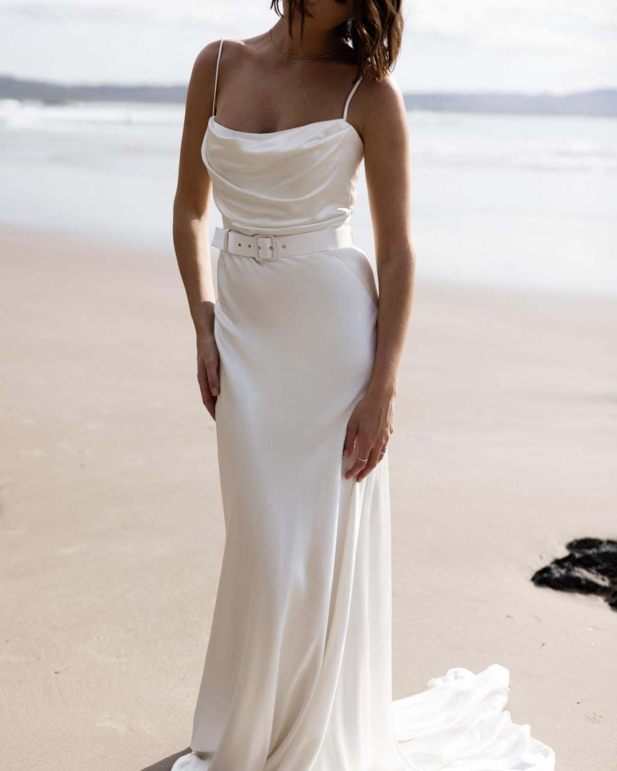 The Tiffany gown by Karen Willis Holmes, a straight neckline, simple satin wedding dress with spaghetti straps.