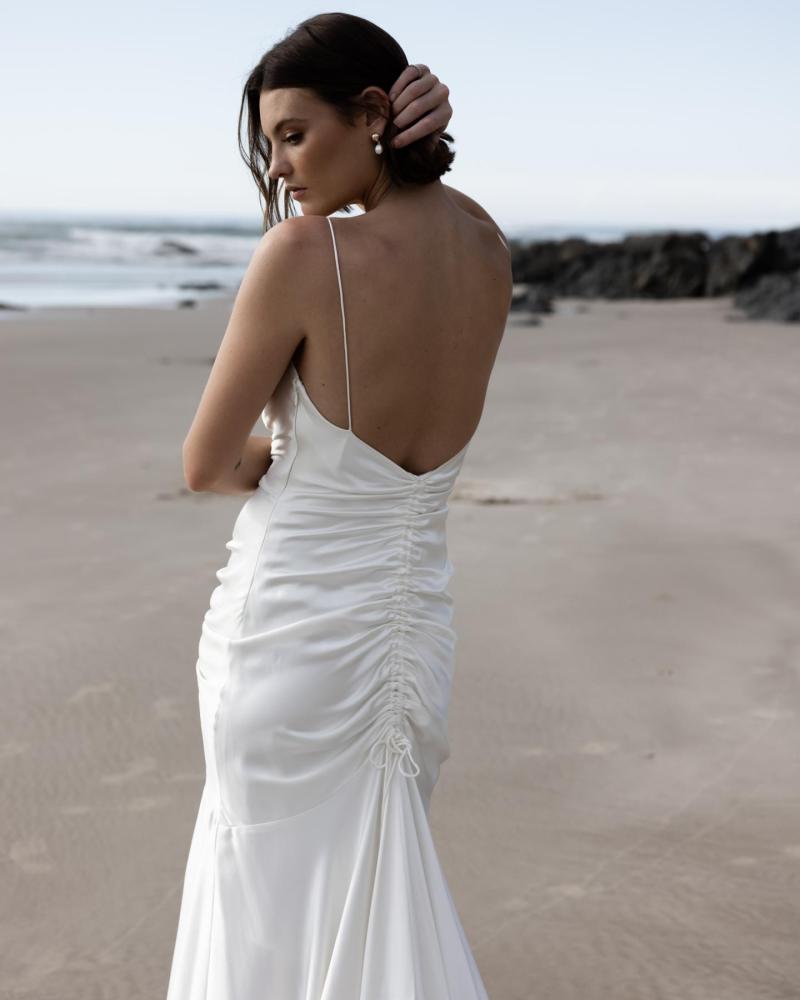 The Tisha gown by Karen Willis Holmes, a sexy, spaghetti strap fit and flare satin wedding dress with a sweetheart neckline.