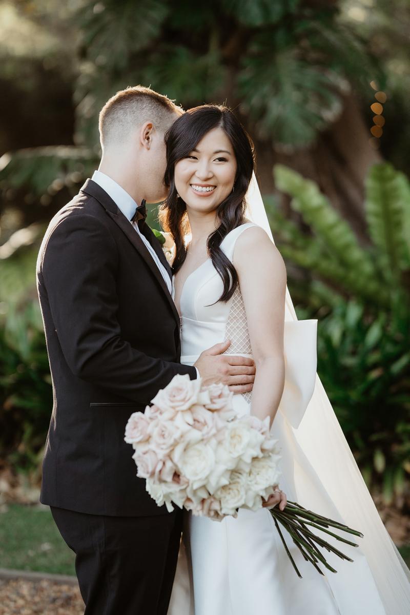 The Shelly Samantha Wedding Dress by Karen Willis Holmes-a V neck traditional dress- couples photo with floral bouquet