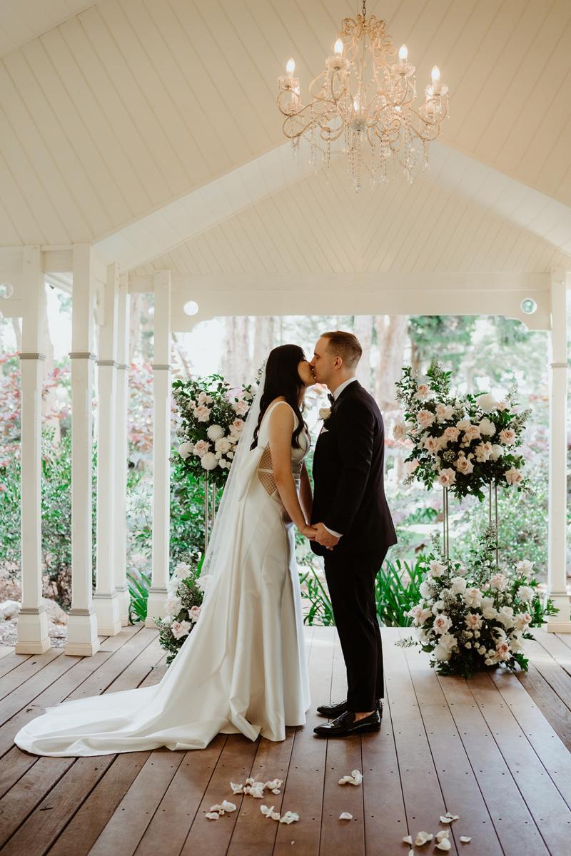 Shelly Samantha wedding dress by KWH Bridal-getting ready photo with custom back bow kissing at Gabbinbar Homestead