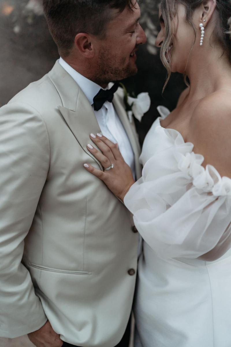 CATALINA - Karen Willis Holmes- Bride & Groom hold each-other, while bride wears our gorgeous Catalina Gown