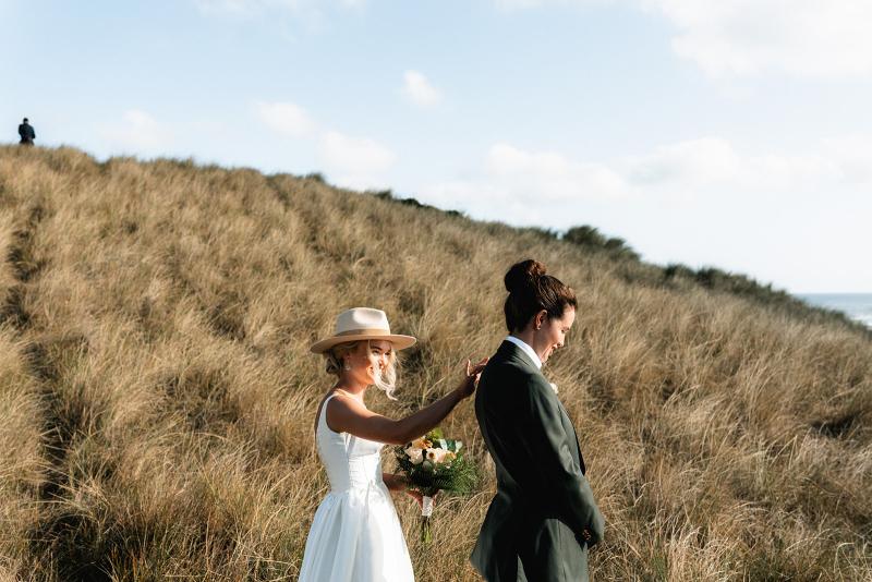 Taryn Camille_Karen Willis Holmes_Emma & Emily - Same sex brides seen on the South Coast, surrounded by endless views of the coast line. Bride Emily has chosen the iconic Taryn Camille gown from the BESPOKE collection.
