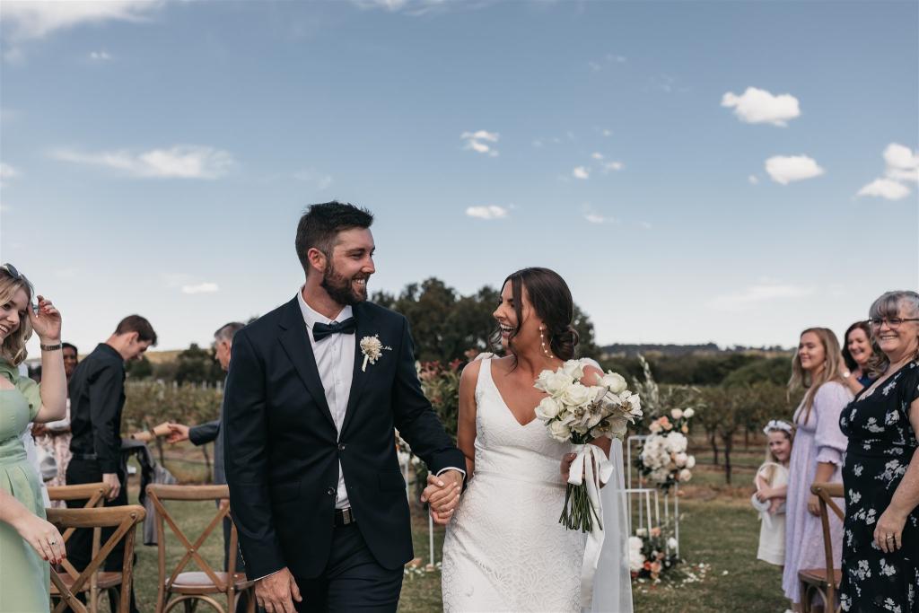 Lorissa & Recce-Rylie-WILD HEARTS collection - Bride and Groom celebrating their love and marriage surrounded by endless views of vineyards and organic structures.