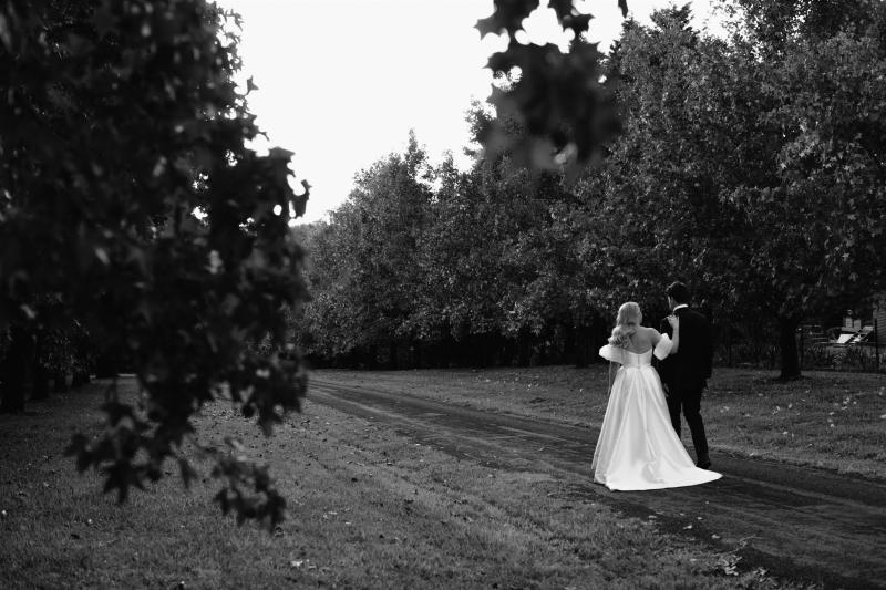 Jacqueline & Elizabeth - Karen Willis Holmes - Chole & Edward - Bride and groom taking their romantic couple portraits in the garden of their wedding venue. Bride is wearing a modern favorite, known as the Jacqueliene Elizabeth gown from the BESPOKE collection.