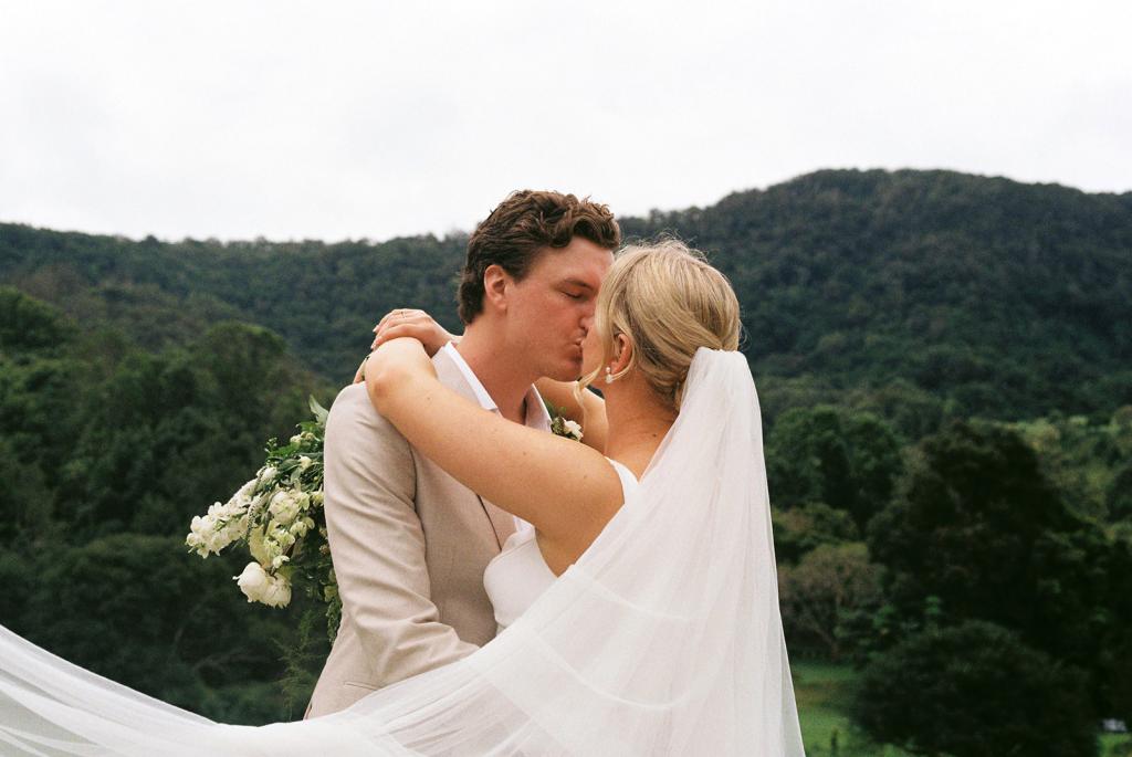 Taryn & Joni - Karen Willis Holmes - BESPOKE - Madeline & Joe - Our KWH Bride is seen wearing the Classic and beautiful, Taryn and Joni gown which is designed with a clean, and simple silhouette.