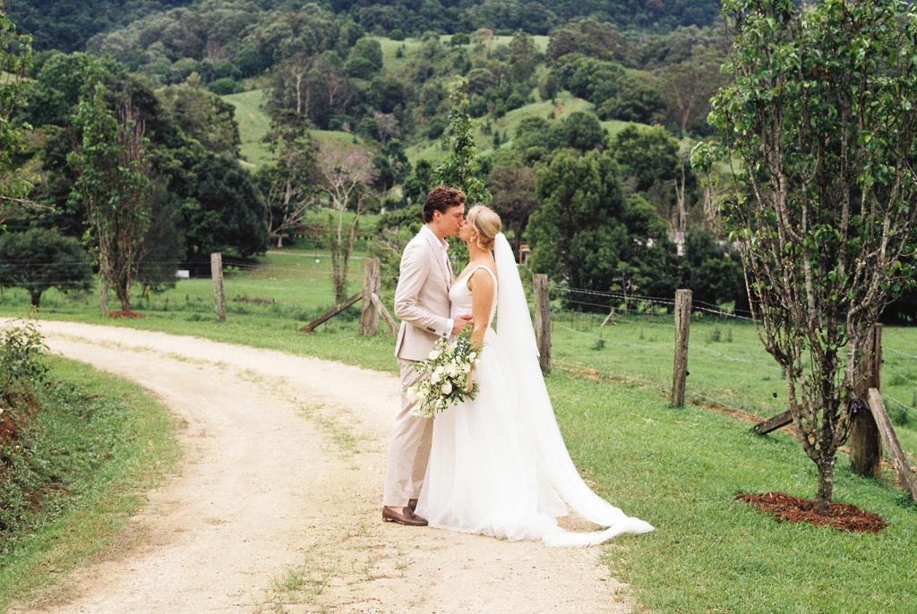 Taryn & Joni - Karen Willis Holmes - BESPOKE - Madeline & Joe - KWH Bride has chosen The Taryn bodice which is fitted and structured with a gorgeous U-shaped neckline made from a satin-finish fabric. This KWH favorite is perfect for our Modern Princess brides.