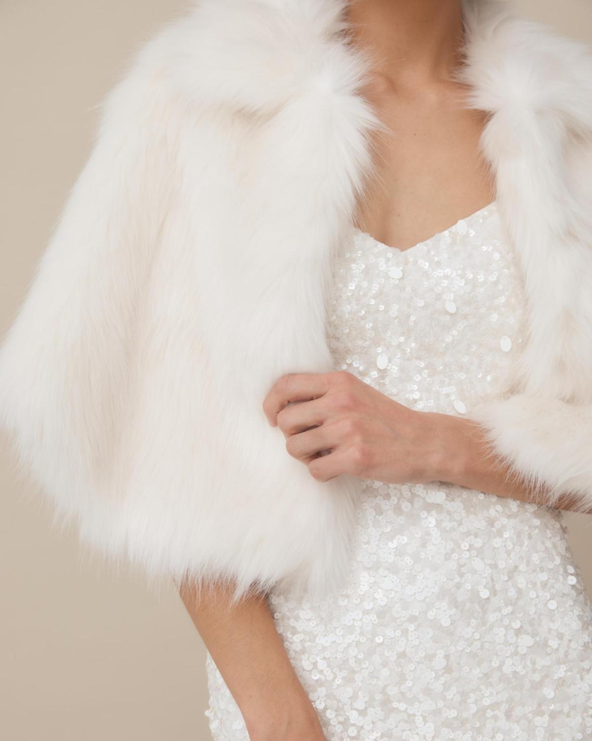 Nord Cape by Unreal fur-a modern wedding cover up made from faux fur worn with the Anya beaded bridal mini