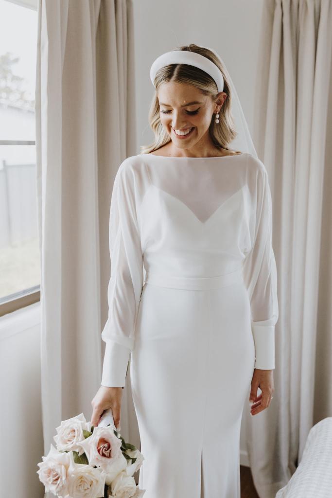 Brie-Karen Willis Holmes - Taylor & Angus- KWH Real Bride Taylor is seen in our minimalist’s dream gown, Brie from our WILD HEARTS collection. This Classic gown features a long sleeve overlay bodice.