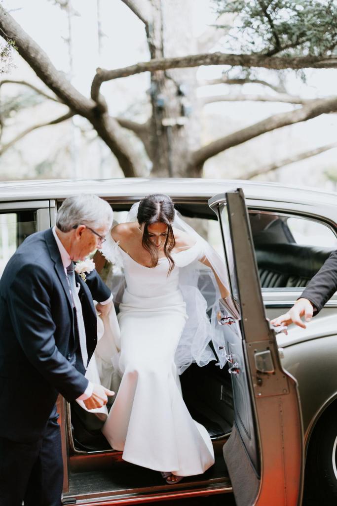 Raven wedding dress by Karen Willis Holmes-getting out of bridal car
