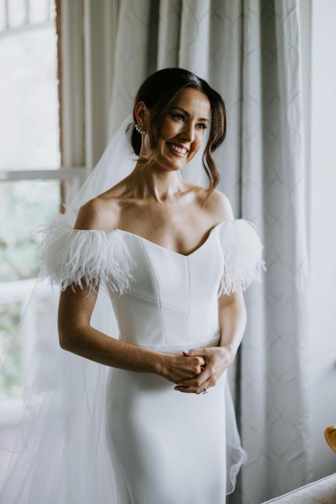 Raven wedding gown by Karen Willis Holmes-bride smiling in dress with wedding veil