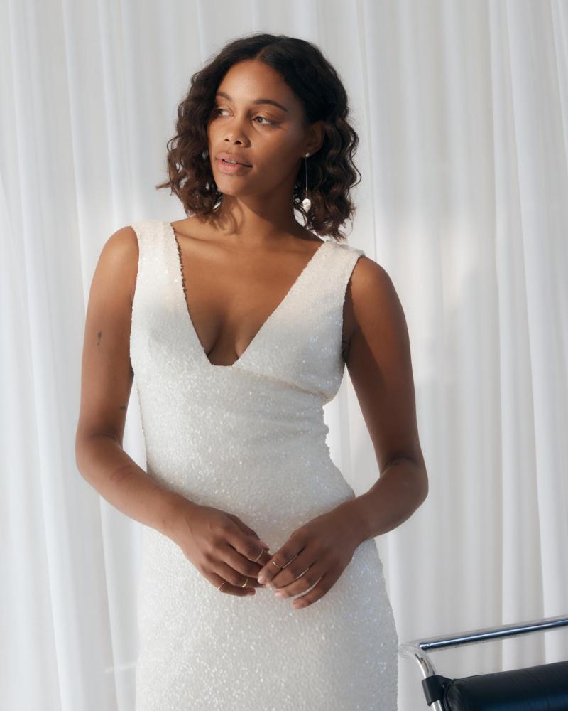Bella is a slim fitting beaded wedding dress with a low neckline by by Karen Willis Holmes